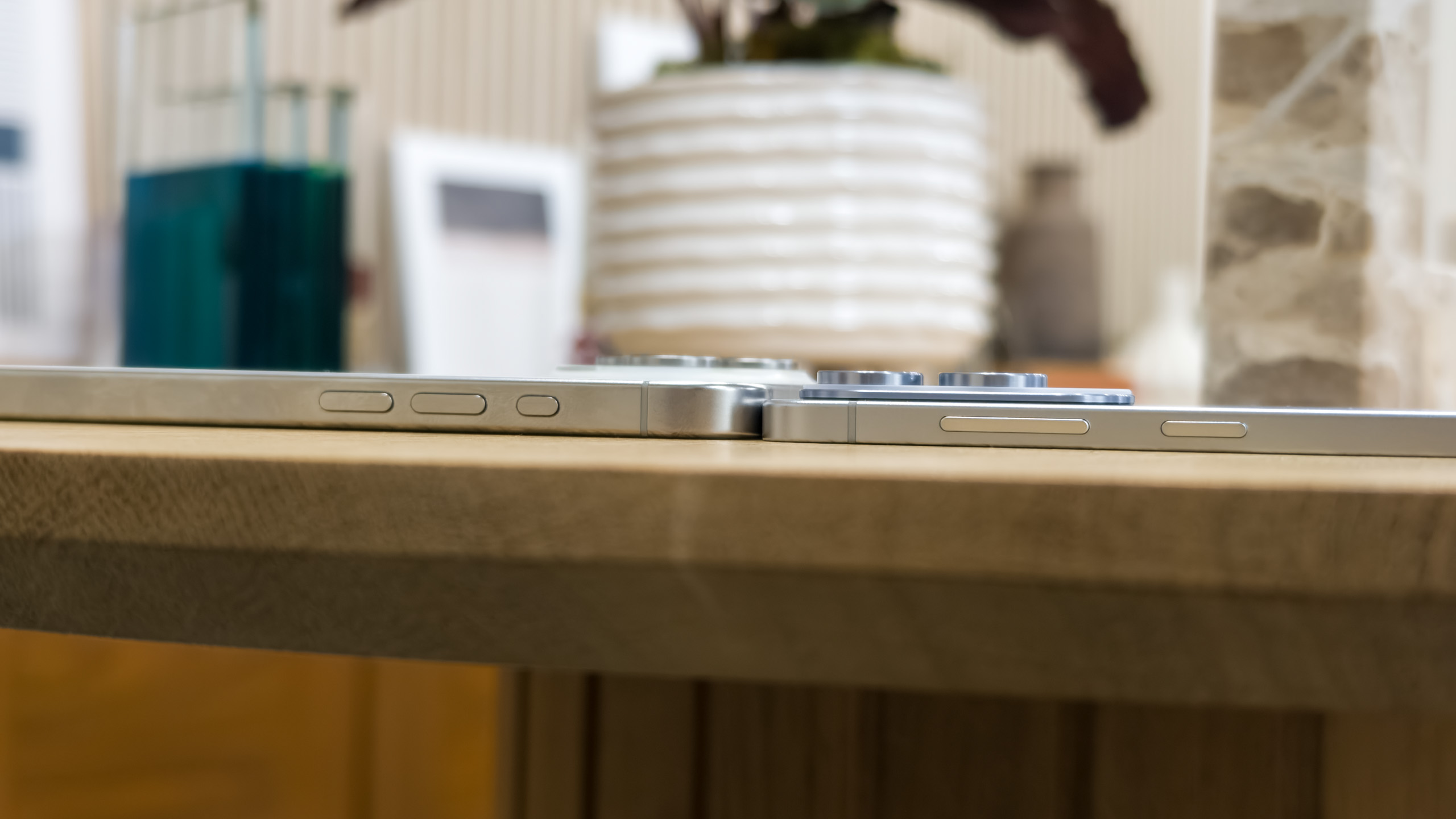 The Galaxy S25 Edge flying flat next to the iPhone 16 Pro