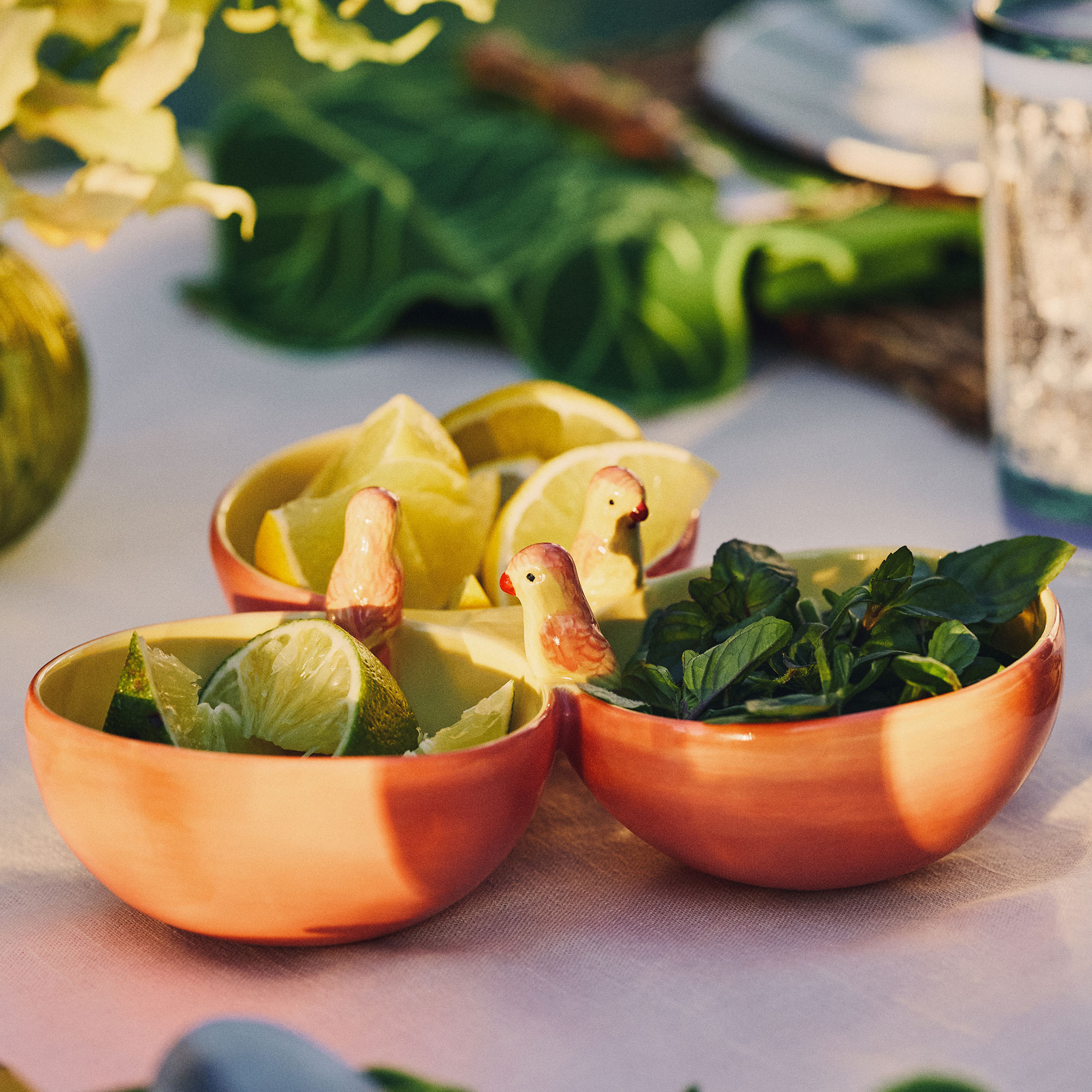 Three section bowl with ceramic parrots on rim