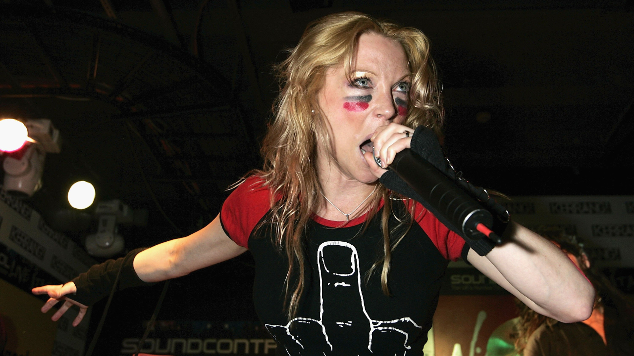 A close up of Angela screaming on stage