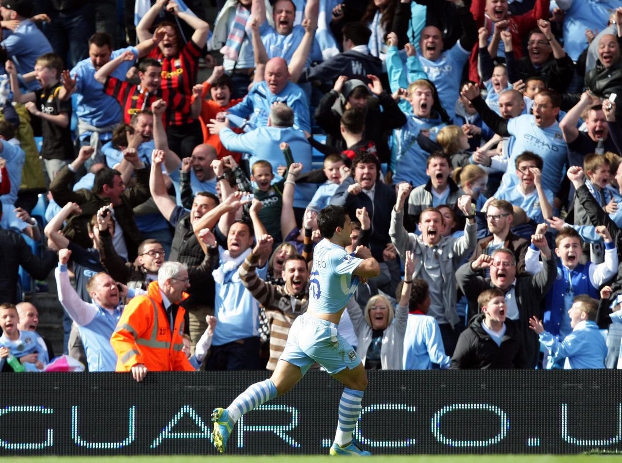Sergio Aguero of Manchester City removes his shirt in celebration after scoring the winning, title-clinching goal against QPR at the Etihad Stadium on the final day of the Premier League season, May 2012