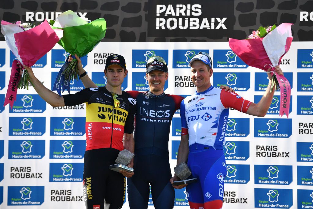 ROUBAIX FRANCE APRIL 17 LR Wout Van Aert of Belgium and Team Jumbo Visma on second place race winner Dylan Van Baarle of Netherlands and Team INEOS Grenadiers and Stefan Kng of Switzerland and Team Groupama FDJ on third place greet each other on the podium during the podium ceremony after the 119th ParisRoubaix 2022 Mens Elite a 2572km one day race from Compigne to Roubaix ParisRoubaix WorldTour on April 17 2022 in Roubaix France Photo by Luc ClaessenGetty Images