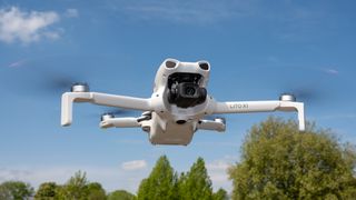 DJI Lito X1 drone in flight against a blue sky