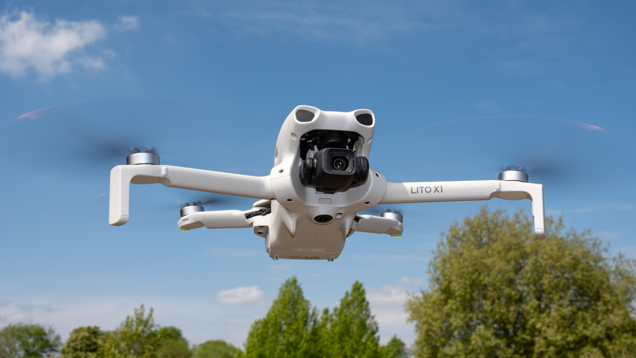 DJI Lito X1 drone in flight against a blue sky