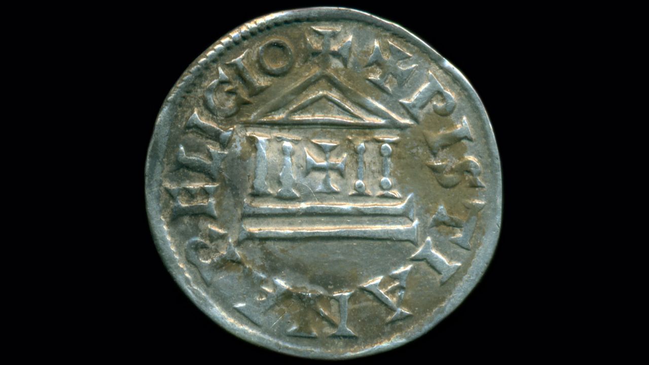 The silver coins are in a distinctive style used by successive Carolingian kings, with Latin inscriptions around a central crucifix and emblem of a temple.