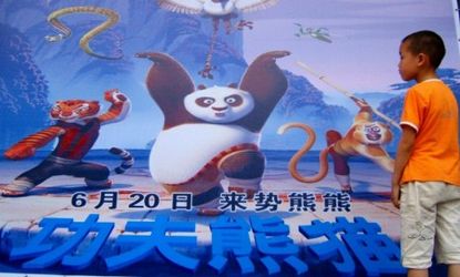 A boy eyes a poster for a DreamWorks movie: The animation studio will create a Kung Fu Panda-themed section within its forthcoming Shanghai-based entertainment district.