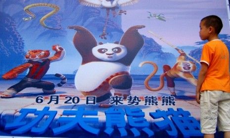 A boy eyes a poster for a DreamWorks movie: The animation studio will create a Kung Fu Panda-themed section within its forthcoming Shanghai-based entertainment district.