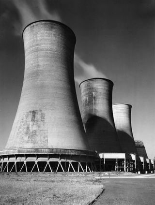black and white photography shwing concrete industrial cooling towers