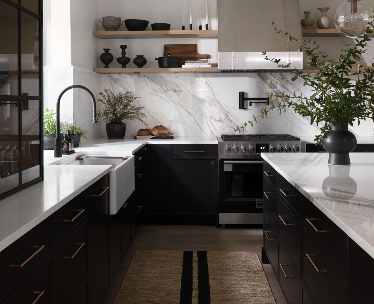 A dark toned kitchen with a woven rug