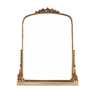 A large gold mirror with a detailed border