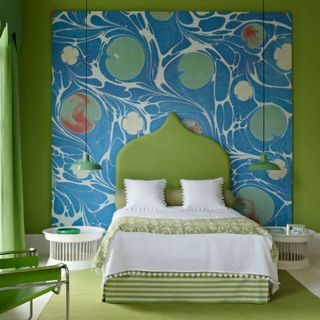 bedroom with pattern wallpaper and green walls