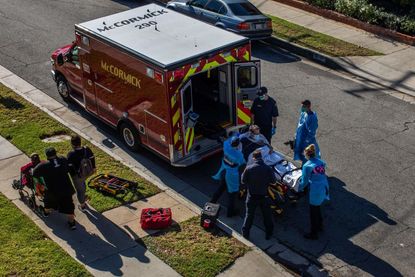 A patient is loaded into an ambulance in Hawthorne, California.