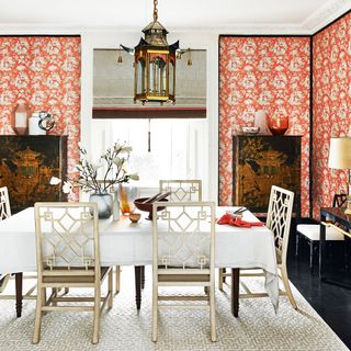 diniing room with printed orange walls and dining table