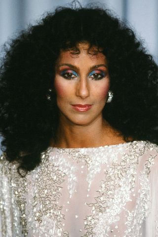 Cher with bold blue and orange eyeshadow
