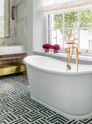 Luxury bathroom with freestanding tub and gold fixtures