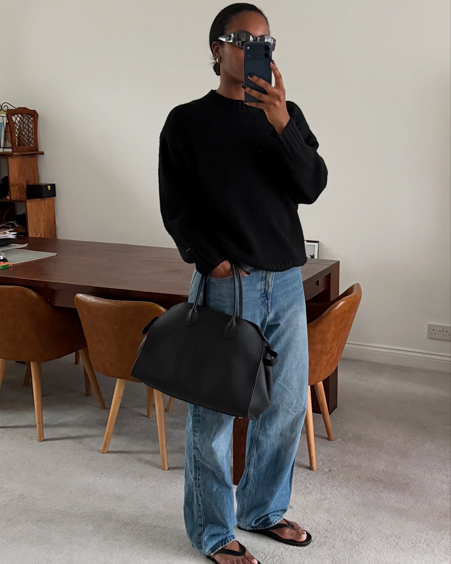 Influencer wearing a long-sleeve tee, relaxed-fit jeans, and flip-flops