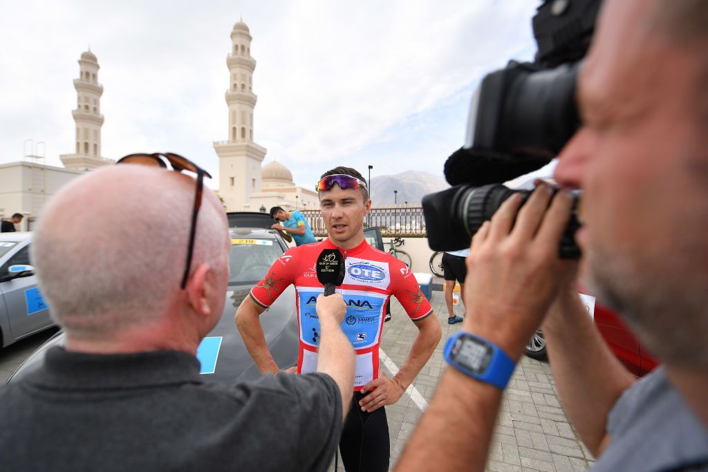 Alexey Lutsenko does a television interview before the start