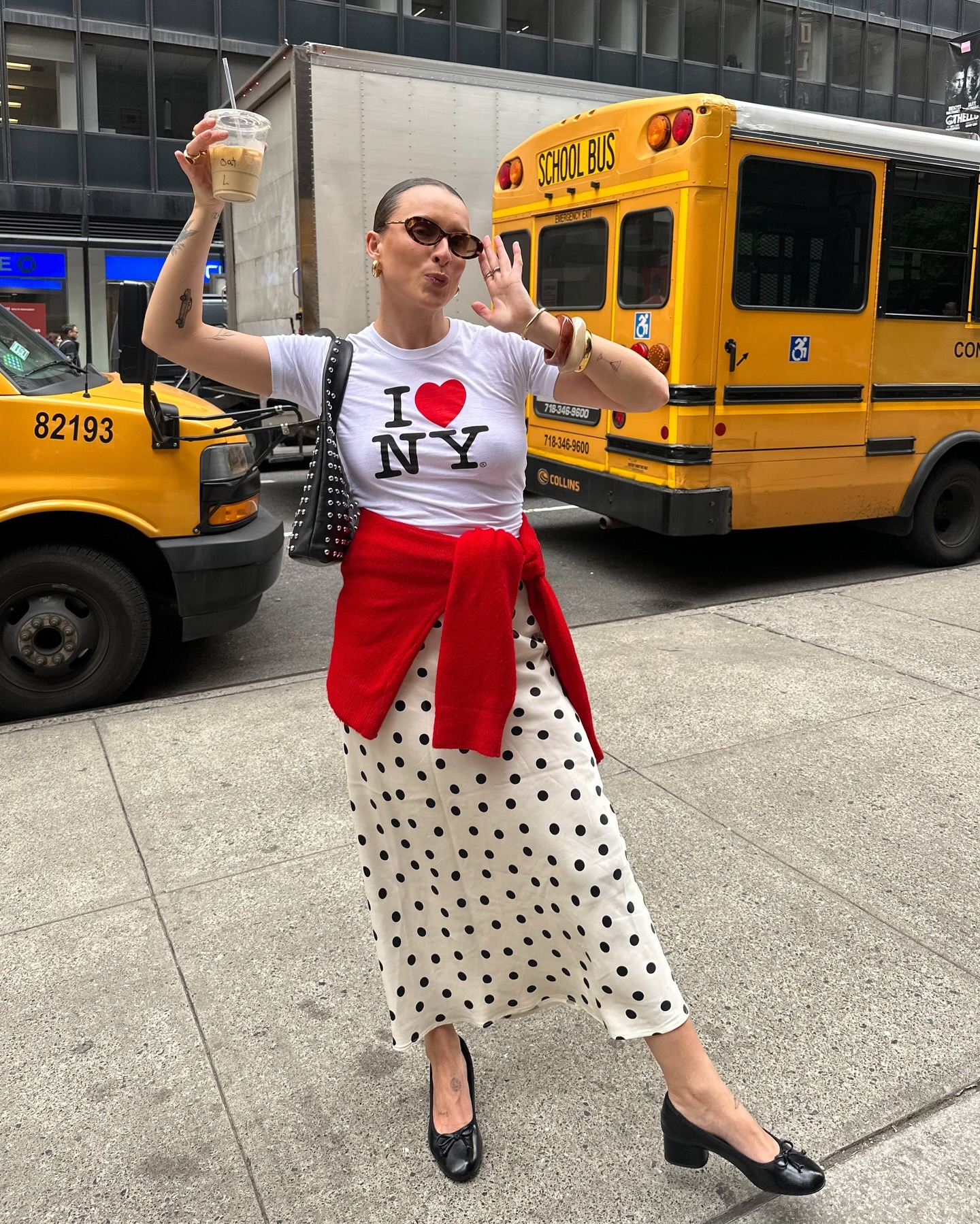 Woman in graphic t-shirt and polka-dot skirt