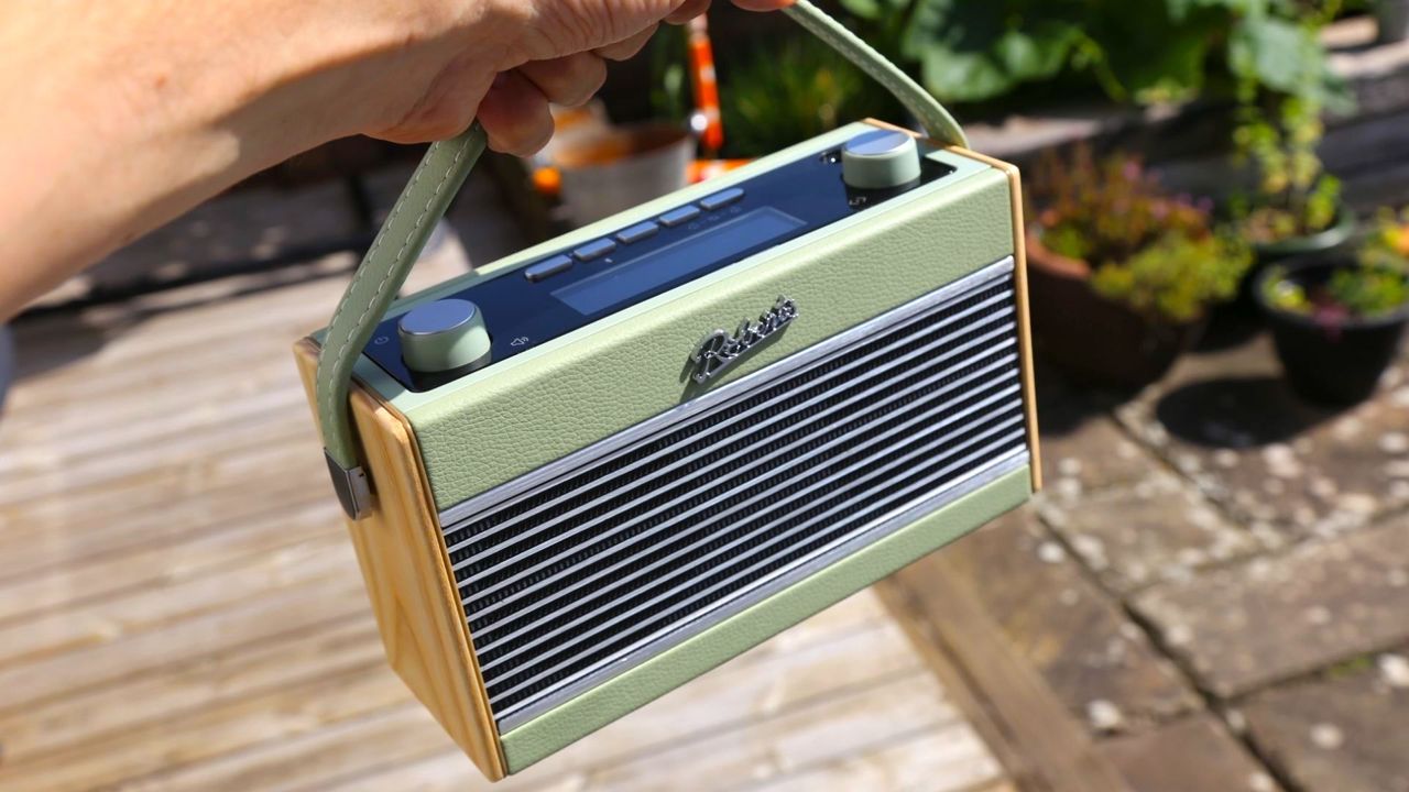 the orberts rambler bt stereo dab radio being helf by its carrying handle