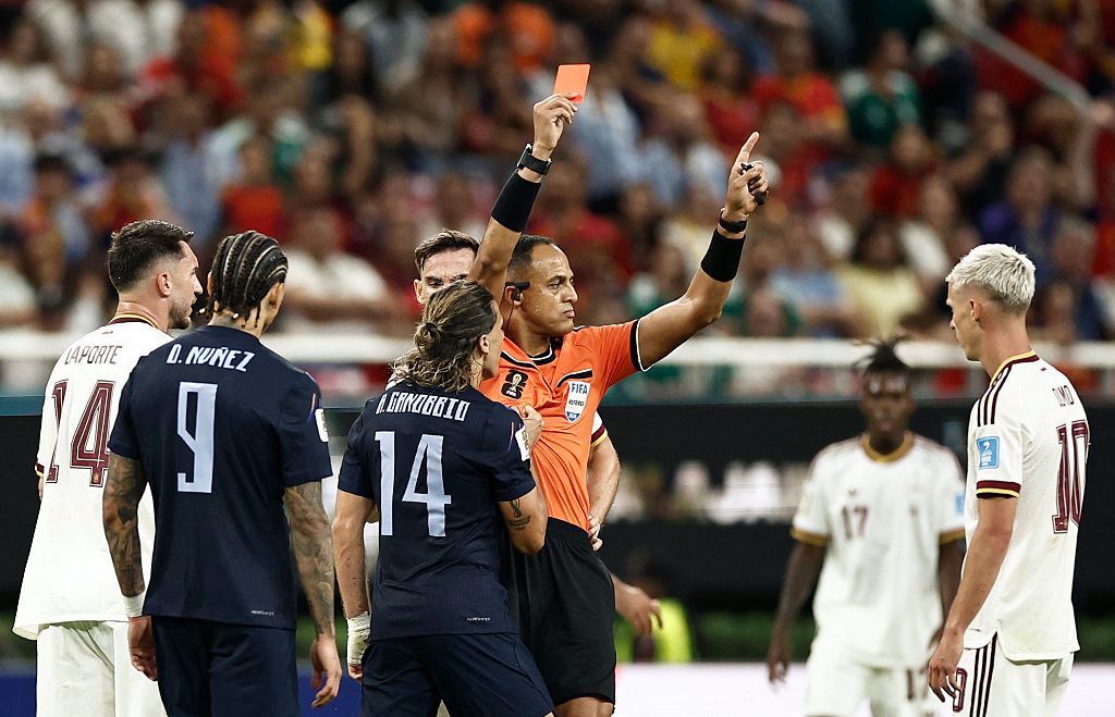 US referee Ismail Elfath shows a red card to Uruguay forward Agustin Canobbio