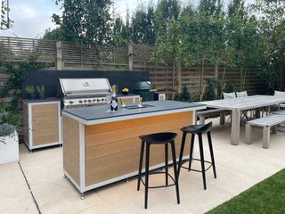 outdoor kitchen with integrated ice bucket in the island