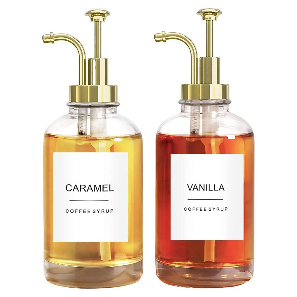 Two syrup dispensers on a white background, one contains yellow caramel and the other a red tinged vanilla syrup