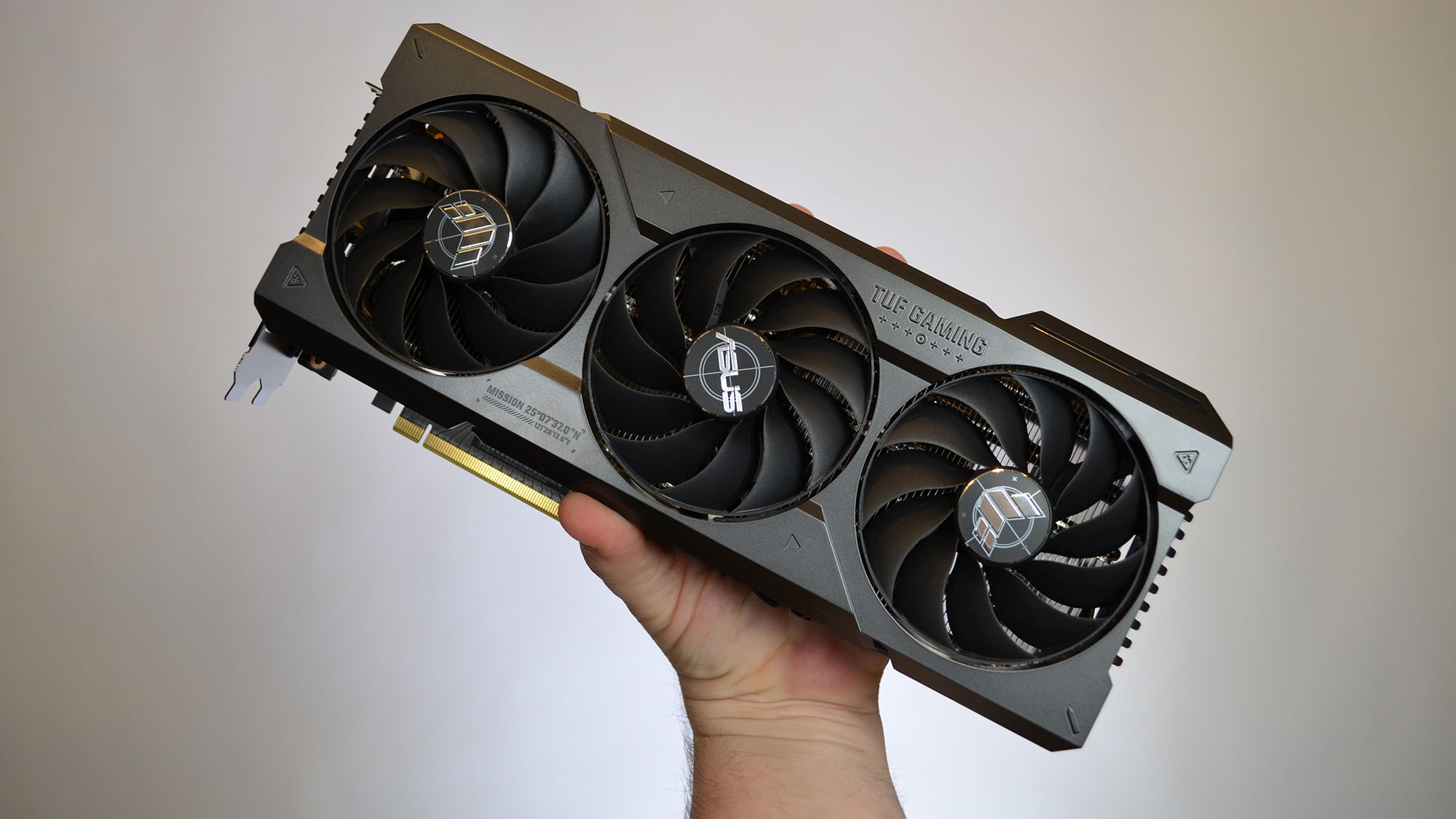 An Nvidia GeForce RTX 4070 Ti graphics card on a wooden table with its retail packaging