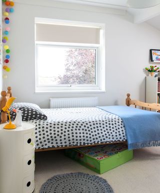 kids bedroom with twin bed and round bedside table