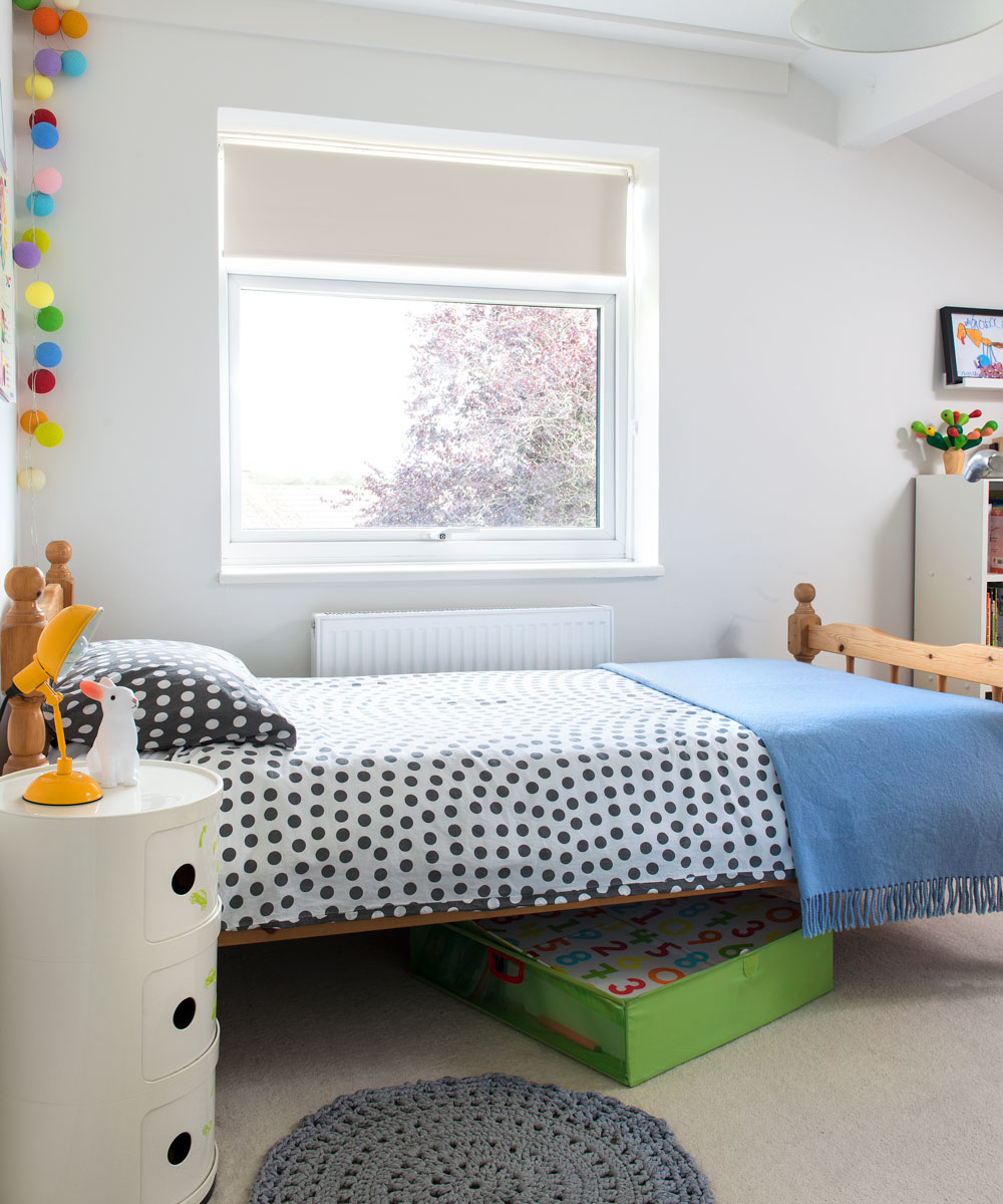 kids bedroom with twin bed and round bedside table