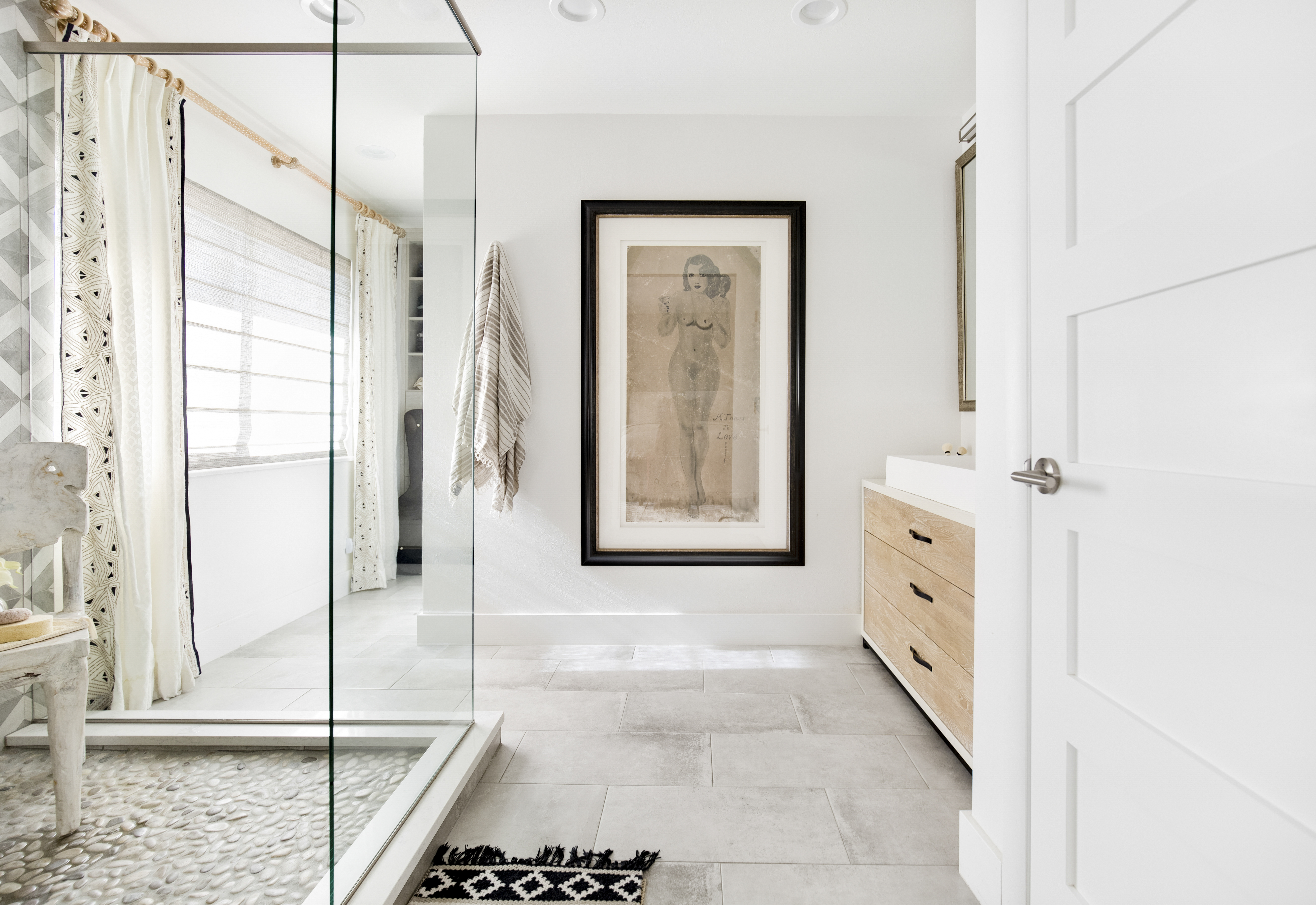 A bathroom with an artwork