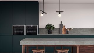 Engineered countertops in minimal grey kitchen with indoor plants and low hanging ceiling lights