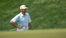 Jason Day looks on whilst waiting to hit a chip shot