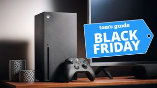 Xbox Series X next to TV on entertainment center with Black Friday deal tag 