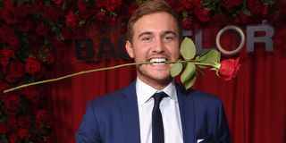 The Bachelor 2020 Peter Weber holds rose in mouth ABC