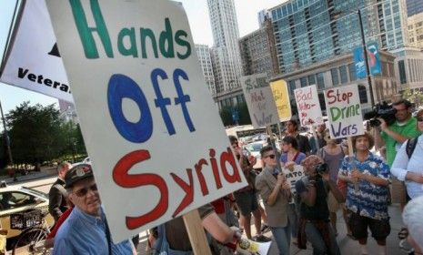 Demonstrators protest against military intervention in Syria outside President Obama&amp;#039;s national campaign headquarters on June 26 in Chicago: Obama said Monday that the use of weapons of mass 