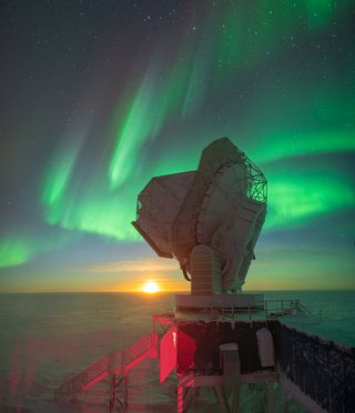 Moonrise at the South Pole with auroras overhead.