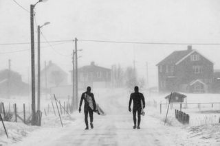 Surfers in the snow image by Chris Burkard