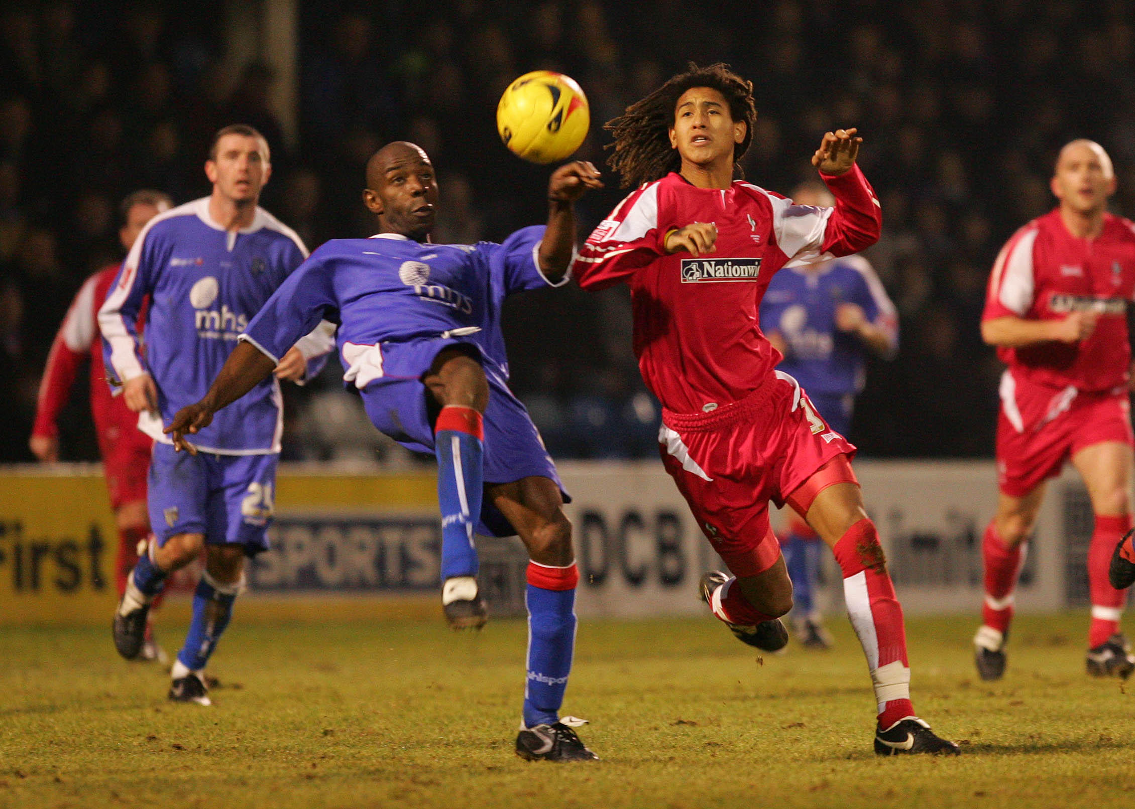 Gillingham's Ian Cox and Swindon Town's Ashan Holgate battle for the ball during a match in 2006