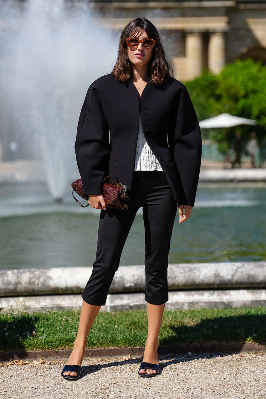 Jeanne Damas wearing a black blazer and capri pants at the Jacquemus show in Paris in June 2025