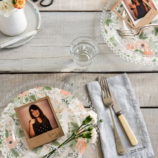 wooden dining table with photo and dinner platters