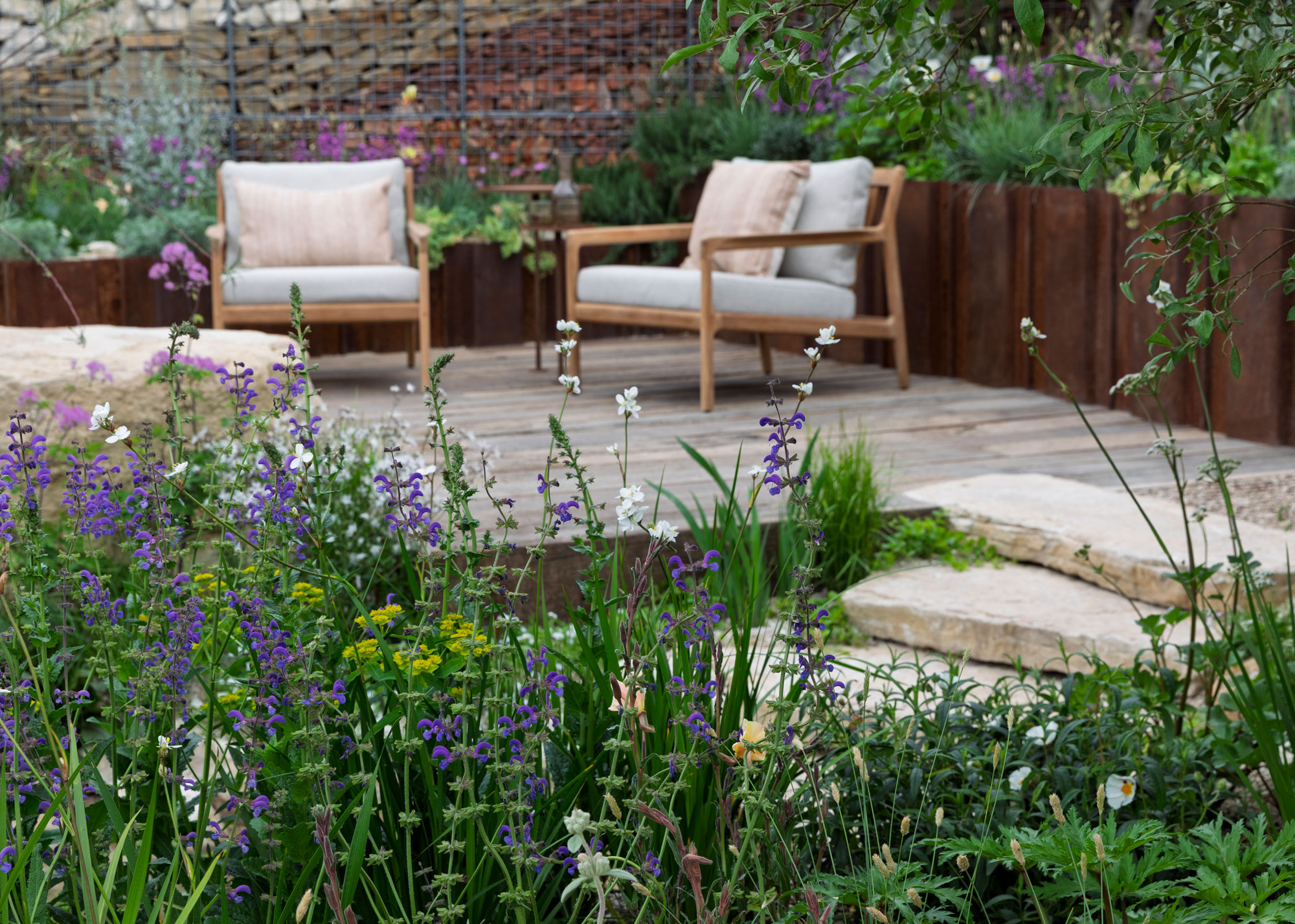 deck with fence, garden steps and planting, leading to garden chairs