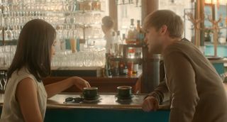 Emma and Dexter have coffee in a cafe.