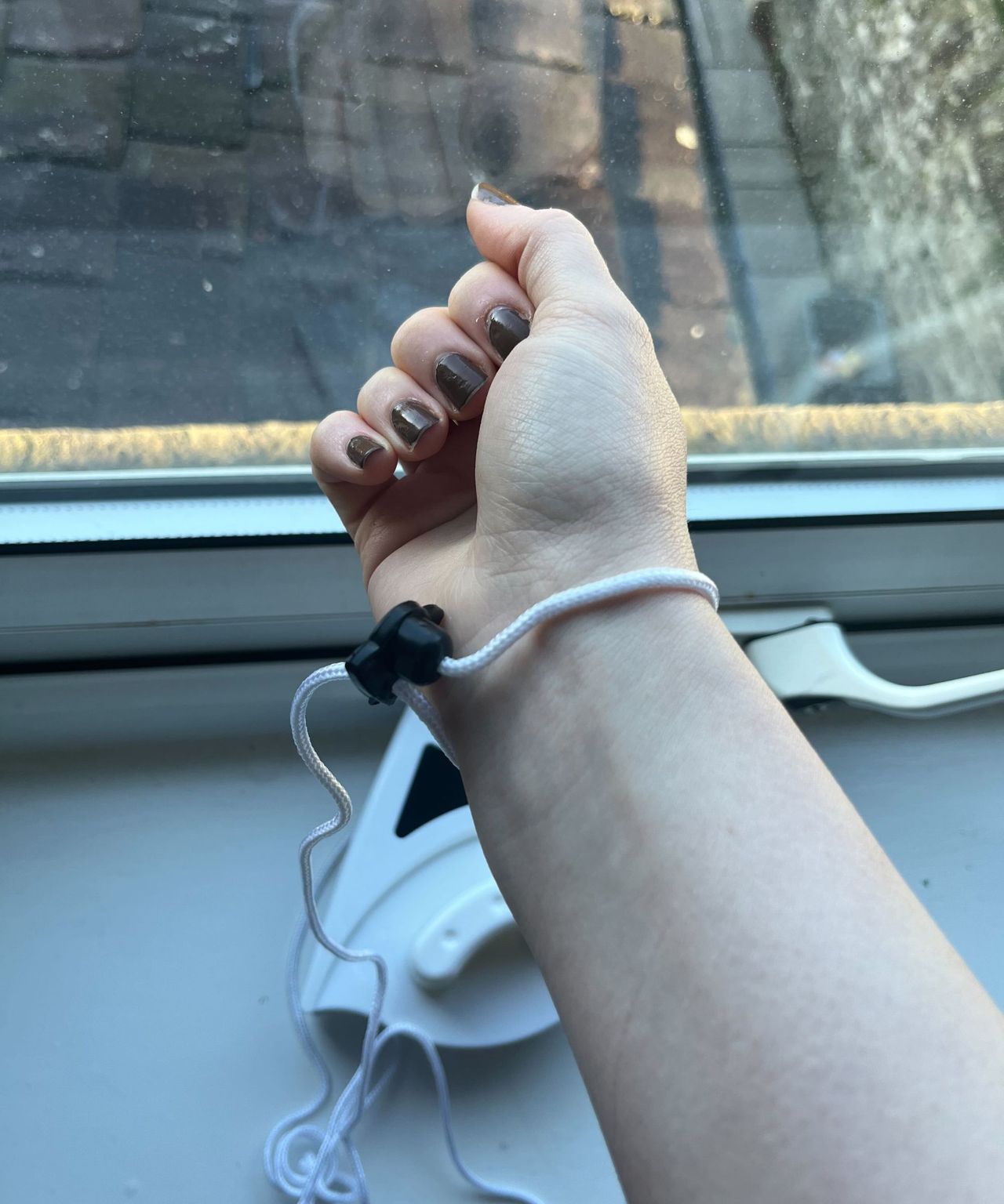 A white wrist strap from the cleaning tool on my wrist