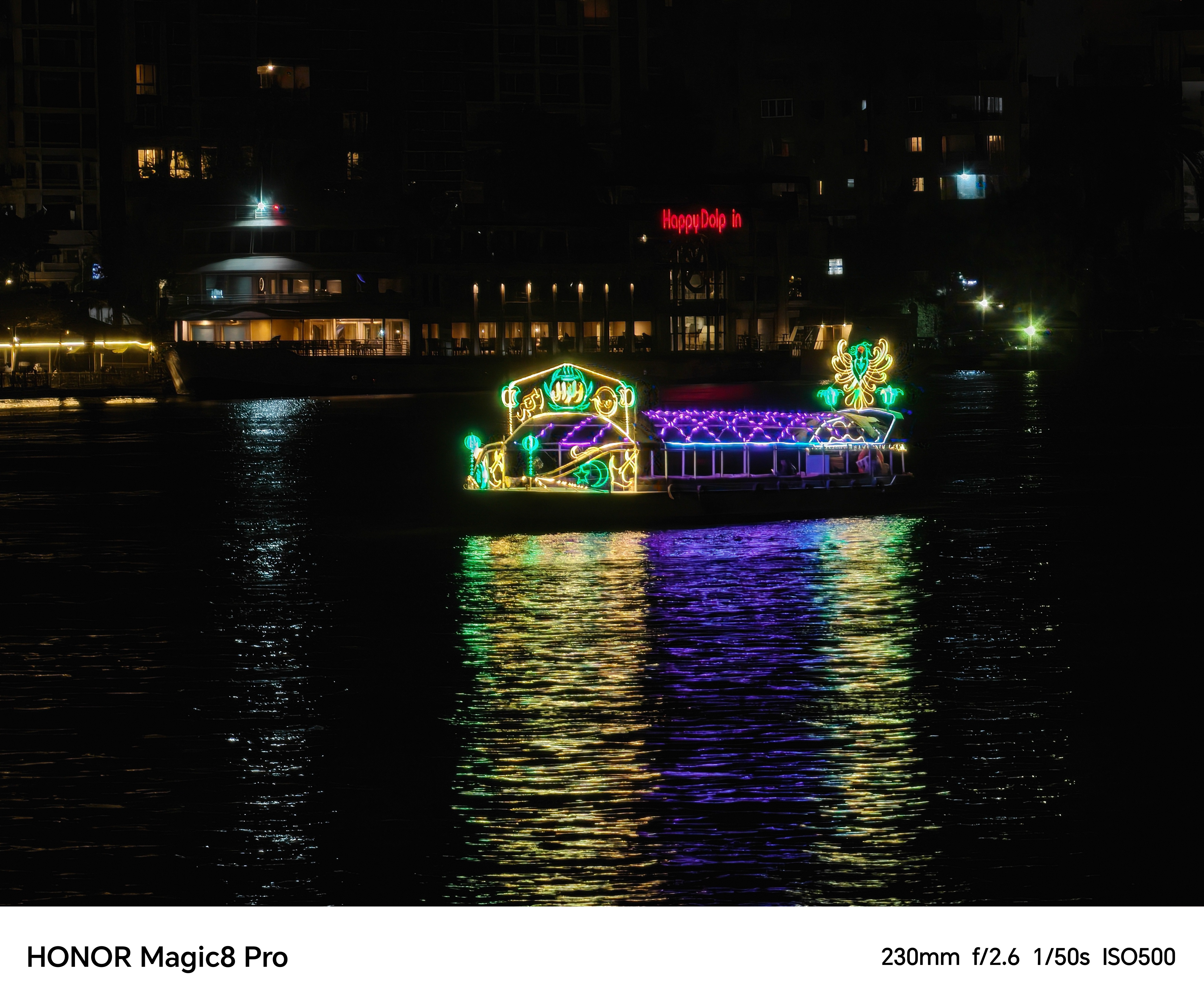 A boat lit up with colourful lights sailing down a river shot on an Honor Magic 8 Pro