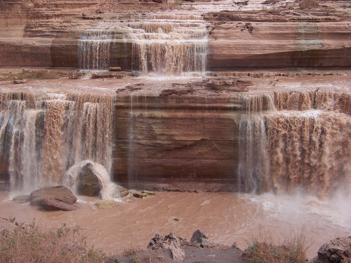 The amazing Grand Falls of northern Arizona come to life each spring when the winter snows melt flows into the Little Colorado River. Affectionately called the Chocolate Falls by locals because of the water’s chocolate color, these falls have a vertical drop greater than the world famous Niagara Falls. Located 30 miles from Flagstaff, Arizona, the Grand Falls is the result of an ancient volcanic lava flow blocking the Little Colorado River channel.