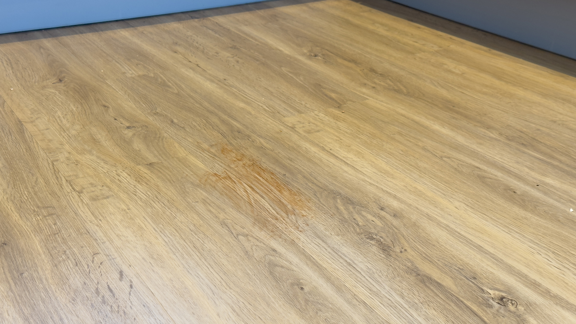 Hard floor with ketchup smeared over it before cleaning