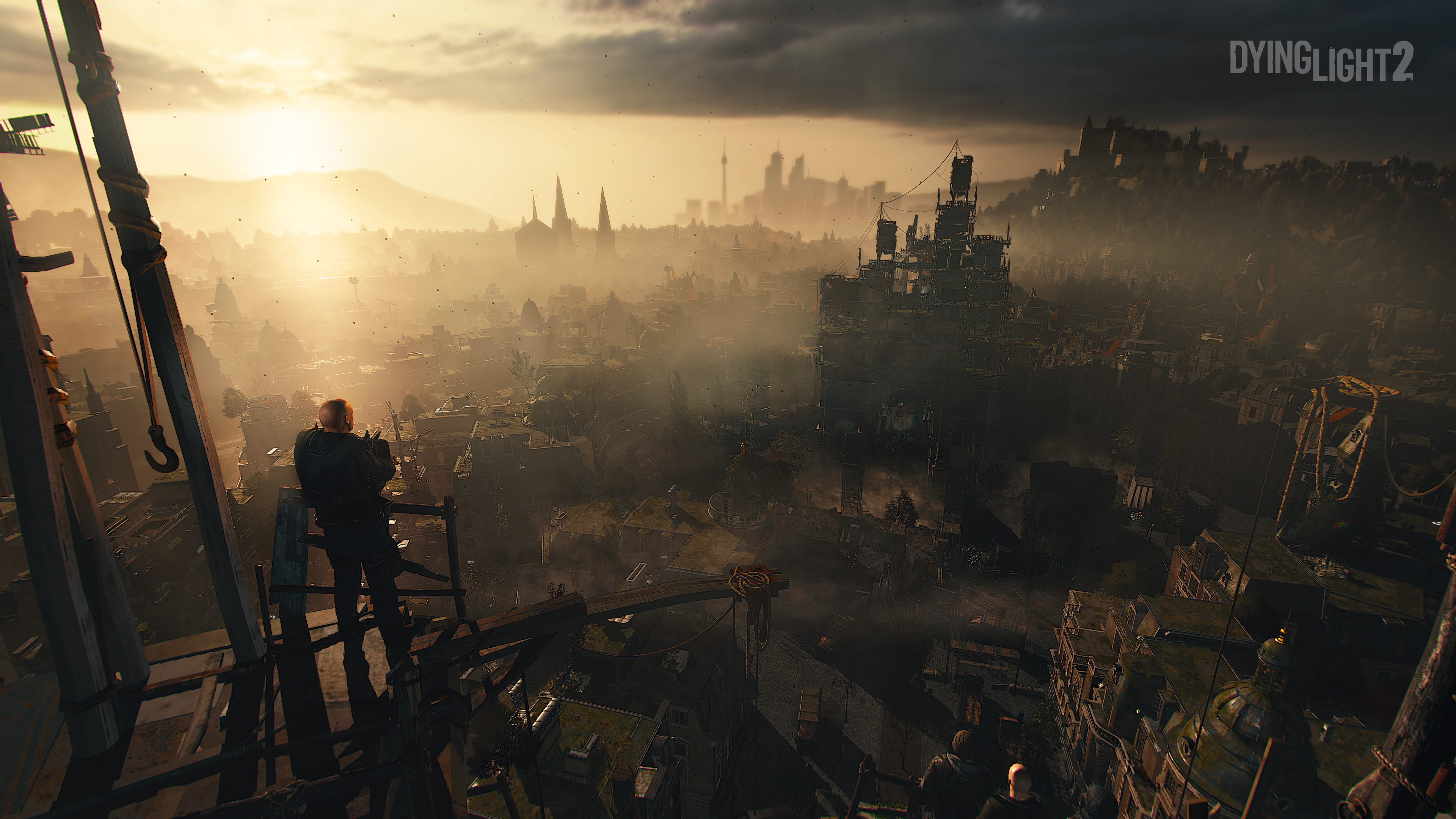 Dying Light 2 - A view from the rooftops down on sunset in the city.