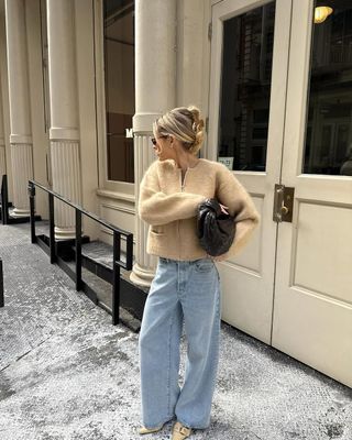 woman wearing neutral outerwear outfit with jeans