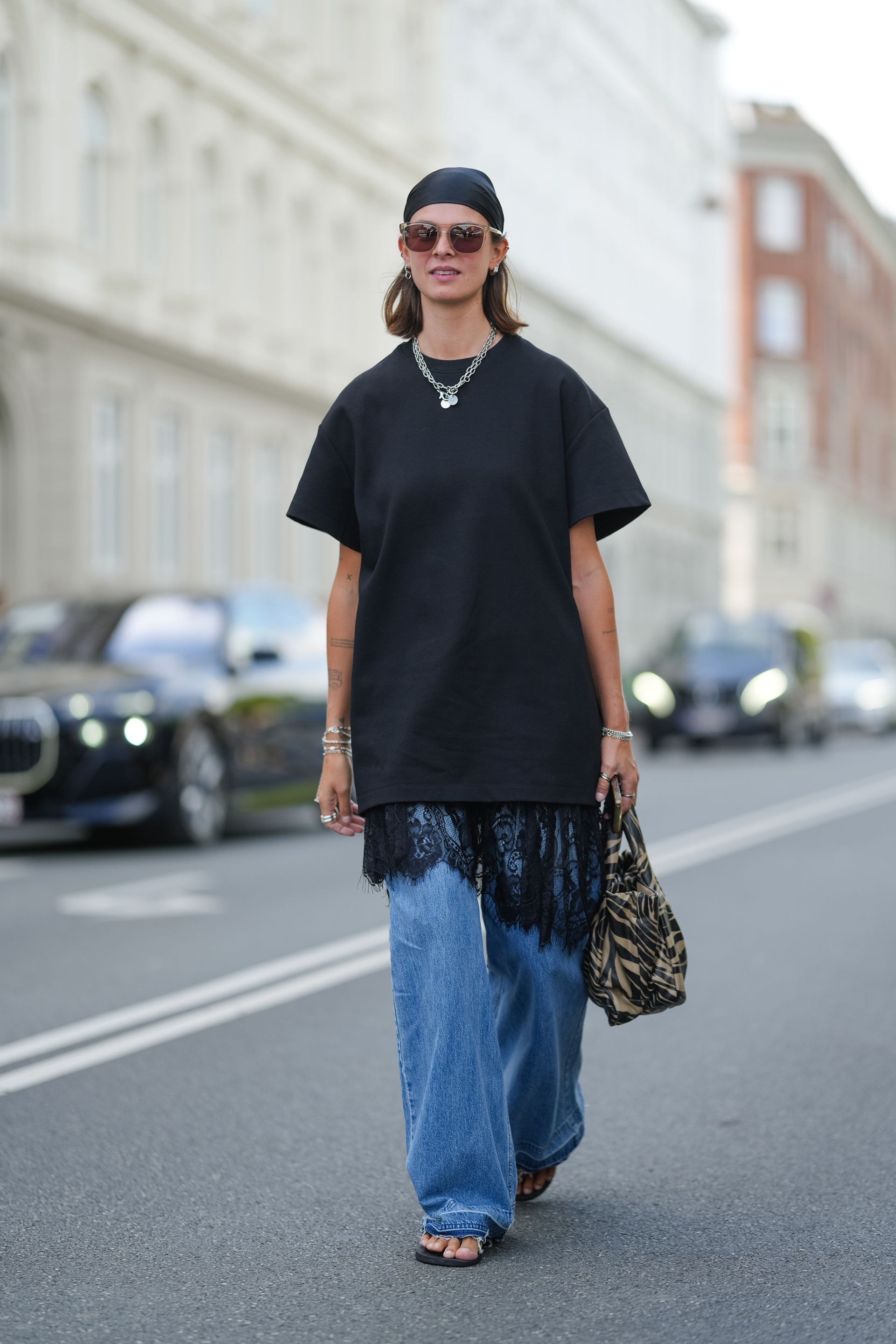 Women in lace trimmed dress over jeans