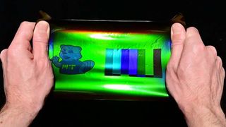 By applying a 19th-century color photography technique to modern holographic materials, an MIT team has printed large-scale images onto elastic materials that when stretched can transform their color, reflecting different wavelengths as the material is strained