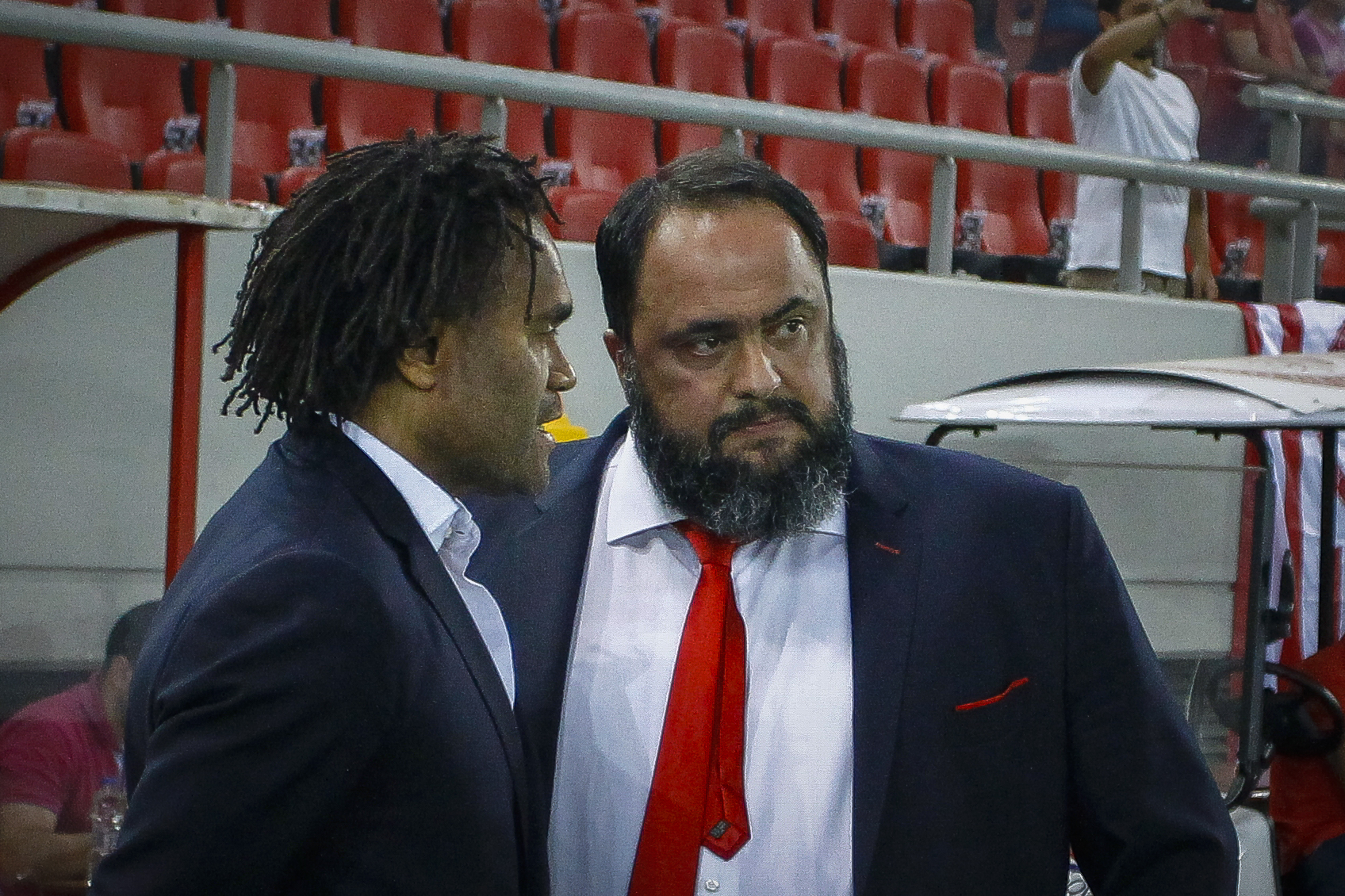 PIRAEUS, GREECE - AUGUST 23: Christian Karembeu Sport Directorof Olympiacos FC with Veggelis Marinakis the owner of of Olympiacos FC during the Europa League - Qualifying Play-Offs - 1st Leg match between Olympiacos FC and Burnley FC at Karaiskakis Stadium on August 23, 2018 in Piraeus, Greece. (Photo by MB Media/Getty Images)